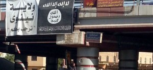 A fighter from the Islamic State, formerly known as the Islamic State of Iraq and the Levant (ISIL), mans an anti-aircraft gun mounted on the rear of a vehicle in Mosul July 16, 2014. The Iraqi army and allied Shi'ite militia forces are trying to push back the Sunni insurgents of the al Qaeda offshoot, who swept through northern Iraq last month to within 70 km (45 miles) of Baghdad. Picture taken July 16, 2014. REUTERS/Stringer (IRAQ - Tags: CIVIL UNREST POLITICS CONFLICT MILITARY)