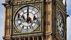 (FILES) A file picture taken in London on August 19, 2014, shows technicians cleaning one of the faces of the Great Clock on the Elizabeth Tower (also known as Big Ben). The most famous clock in the world is wrong: the bongs of London's Big Ben have been mysteriously running fast over the past fortnight, clocksmiths admitted Tuesday August 25, 2015. The Great Clock that towers over the British parliament can be out by up to six seconds, with its keepers admitting the cherished national icon is "a little temperamental" at 156 years old.  AFP PHOTO / BEN STANSALL/FILES