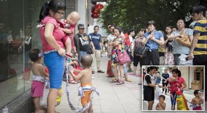 Pic shows: The mother giving away her kids on street.nnAuthorities have ordered a woman to check herself and her three children into a rescue shelter after she was seen trying to give them away to the public.nnThe mother who was not named but who is reportedly 25-years-old, was seen begging in front of a metro station in Guangzhou, capital of south China¿s Guangdong Province, not for money, but for someone to take her three sons off her hands.nnThe three boys, an 8-month-old, 2-year-old, and a 3-year-old, had been abandoned by their father and left in the care of their mother several days ago, she claimed.nnAnd the young mother, who was jobless, further maintained that the children were all hers, and she placed the children¿s birth certificates on the ground as proof.nnShe told passers-by that she was unable to raise her sons as she could not even feed them or provide a roof over their heads, and that she hoped some kind-hearted citizens would adopt them.nnGuangzhou police arrived on scene after witnesses alerted them of the mother¿s appearance outside the metro station.nnPolice have reportedly ordered the reluctant mother to send her children to a rescue shelter, where she may also seek refuge until she finds a job.nn(ends)